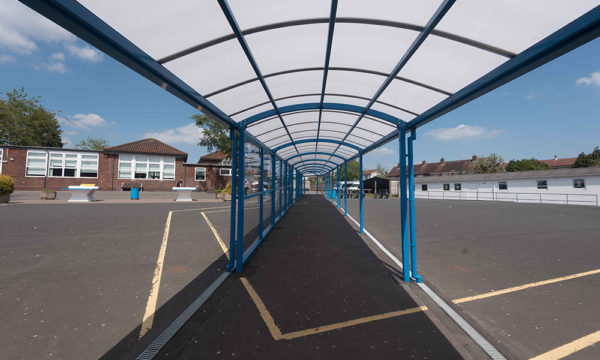 Polycarbonate roof covered playground walkway