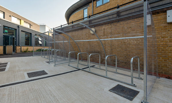 Semi-enclosed cycle shelter with single row of bike stands