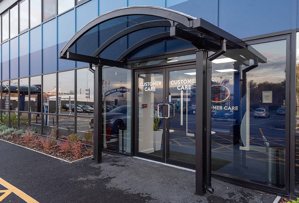 Glass entrance canopy outside commercial property